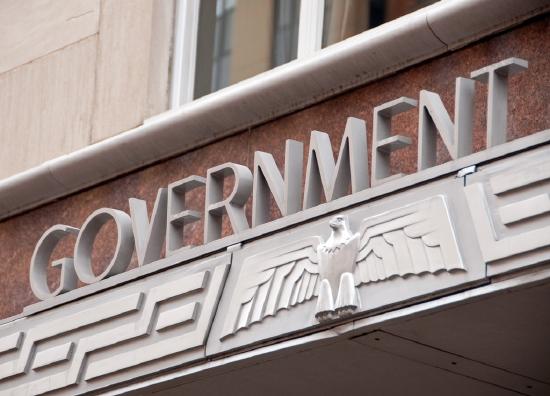 Art Deco sign on building saying Government with a stylized eagle underneath