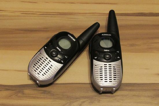 Two walkie talkie type hand held devices