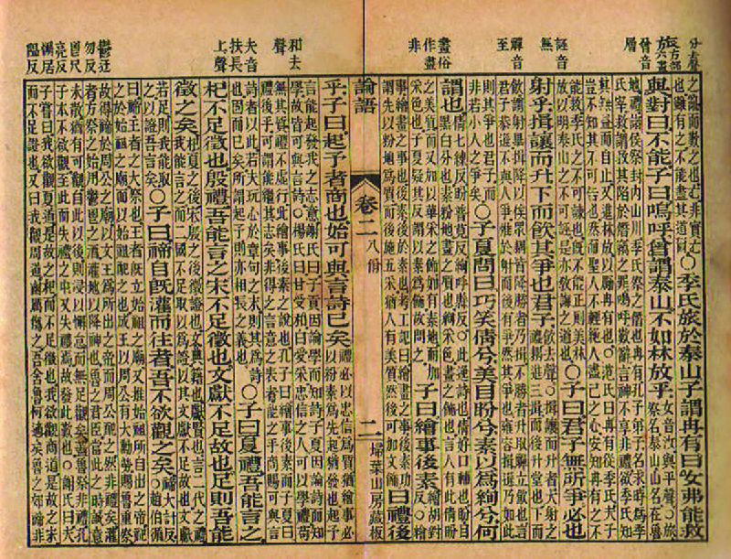 Un morceau de bambou comporte des caractères chinois écrits à l'encre qui sont organisés en colonnes.