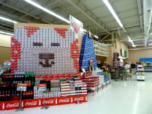 A wall of Coca Cola 12-packs that are arranged in a display look like a polar bear