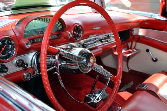 the steering wheel and dashboard of a classic automobile.