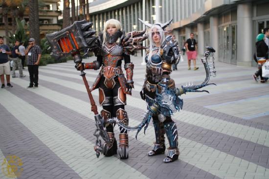 Two female Blizzcon attendees pose outside the venue dressed in elaborate videogame character costumes.