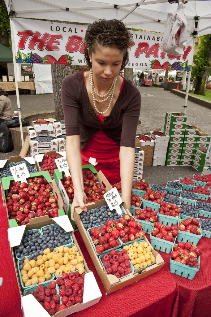 A woman at a farmer's market stand