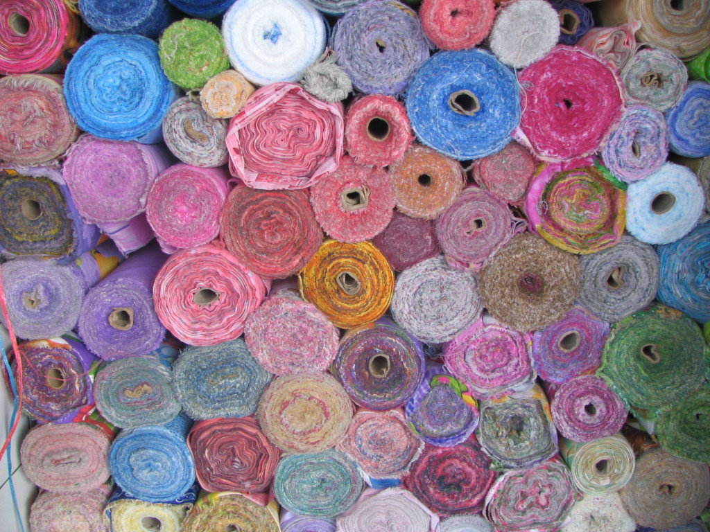 A stack of rolled-up carpets