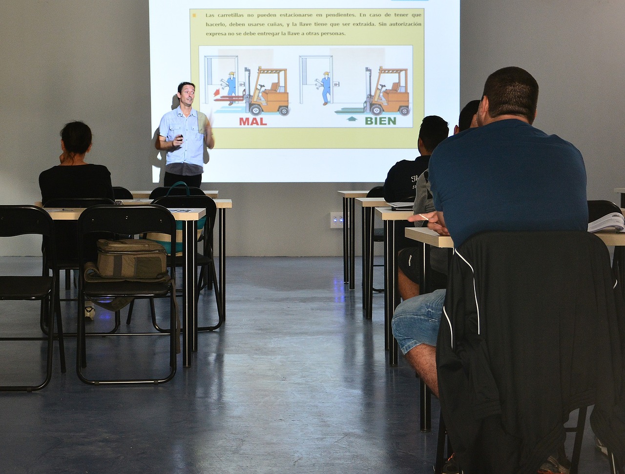 A group of employees listens to a man give a presentation