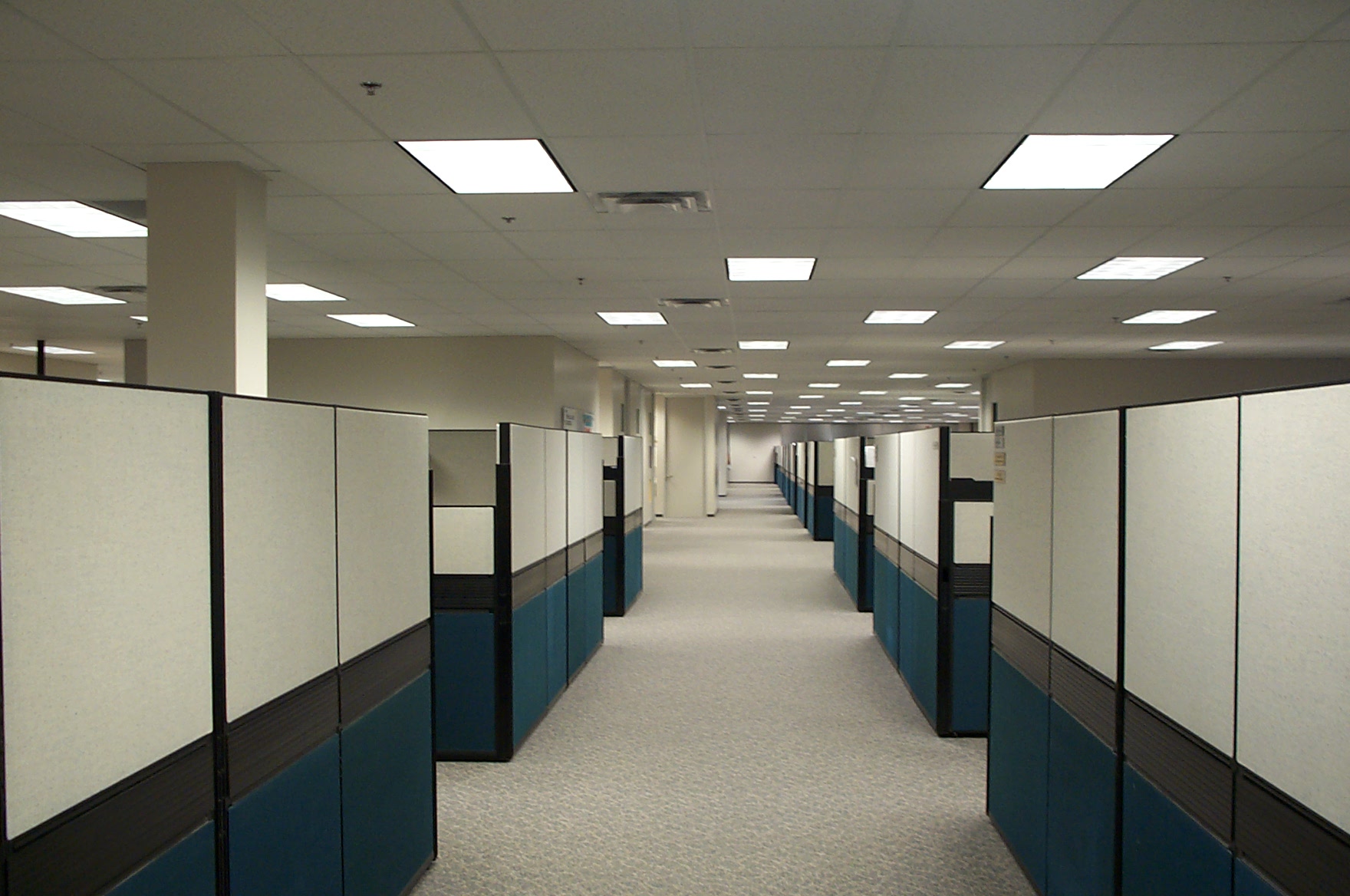 an empty office with rows of cubicles