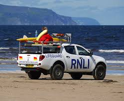a lifeguard pickup truck on the beach