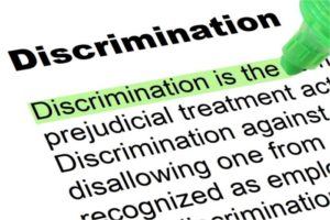 Dictionary entry for of discrimination. Definition is "Discrimination is the unjust or prejudicial treatment of different categories of people." Green highlighter is marking the definition.