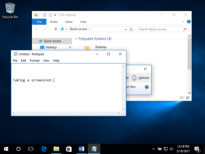 Image of a Windows 10 Desktop with two individual windows open. One is a file finder and the other is a textbook. A screen grab is in progress.