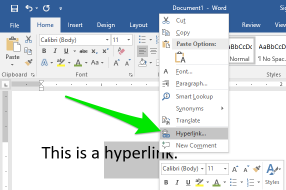 A Microsoft Word document is open with one sentence of text on it. The last word in the sentence has been double clicked which has lead to a new dropdown menu. There is a large green arrow pointing to a feature on the dropdown menu labeled "Hyperlink".