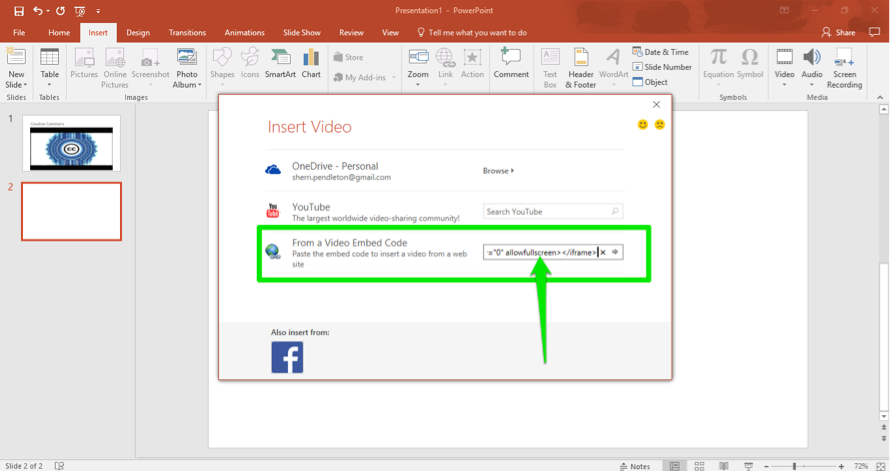 A Microsoft powerpoint is open. An insert video dialog box is open with three options. The third option is selected which is "From a Video Embed Code". A green arrow is pointing at the box where the link has been inserted.