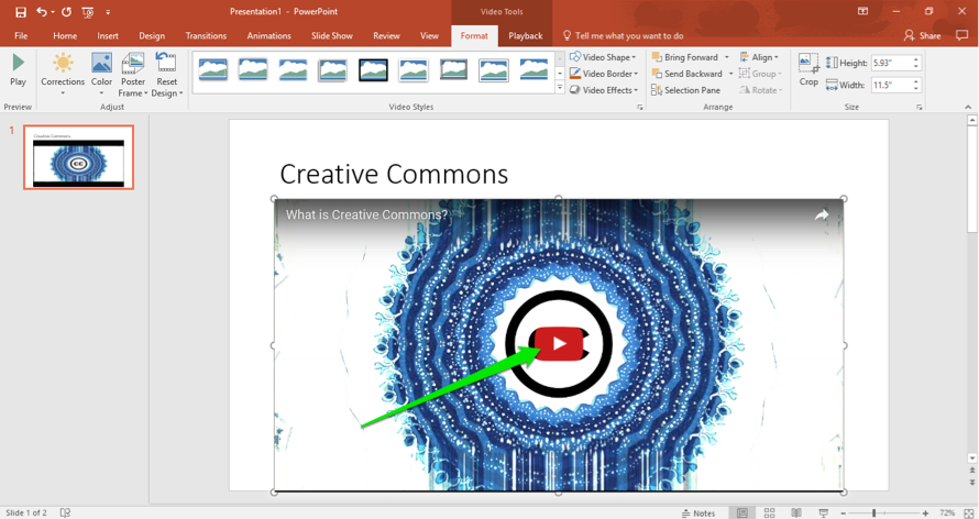 A Microsoft powerpoint is open. A video has been inserted and there is a green arrow pointing to the play button on the video.