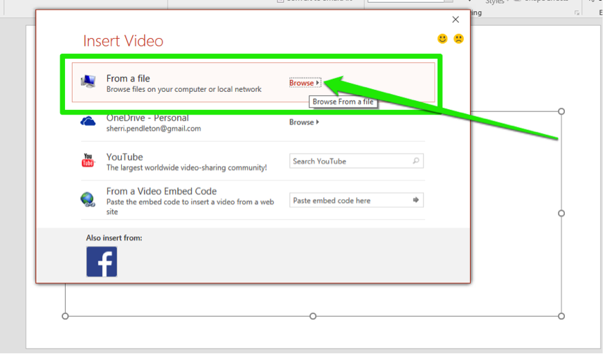 A Microsoft powerpoint is open. An insert video dialog box is open with four options. The first option has been selected which is to choose a video from the computers files. A green arrow points at the browse button.