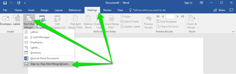 A blank Microsoft Word document is open. There are three green arrows on the document, the first arrow shows that the mailings tab in the ribbon menu has been selected. The second arrow is pointing at the start mail merge button and the third is pointing at the step by step mail merge wizard button.