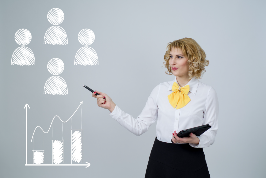 Photo of a business woman. She is standing in front of an illustration of four people and a chart indicating growth.