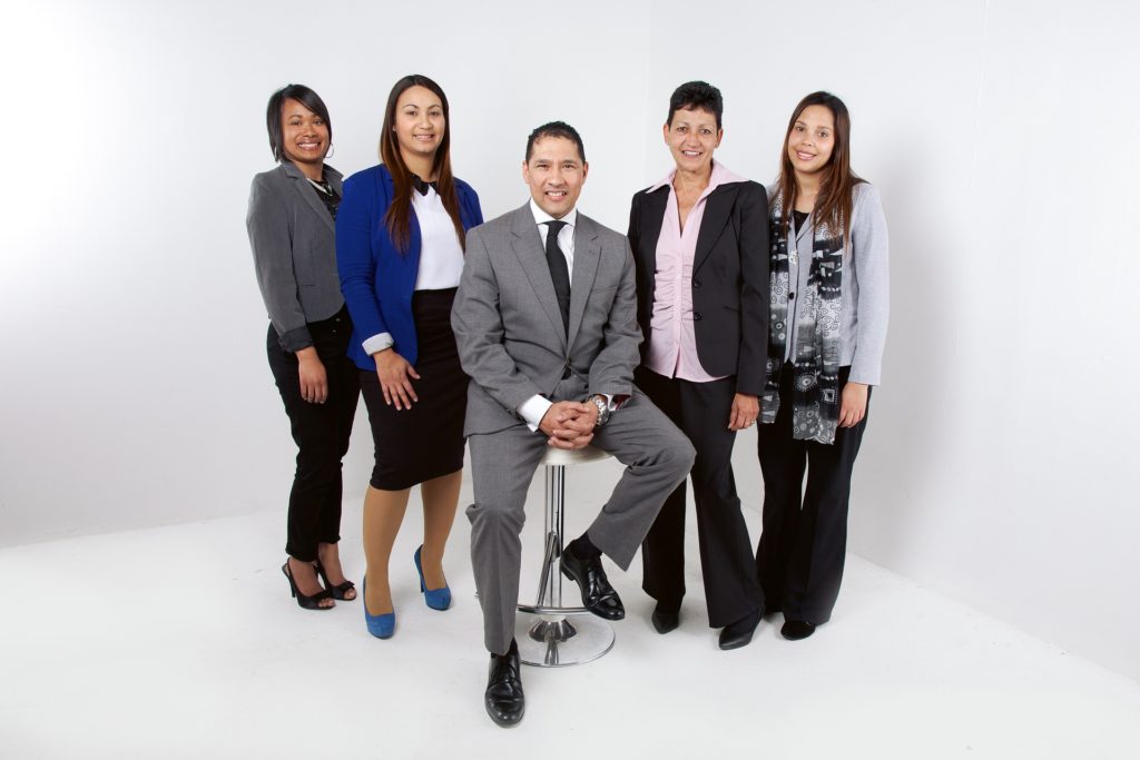 Photograph of five professional individuals standing around