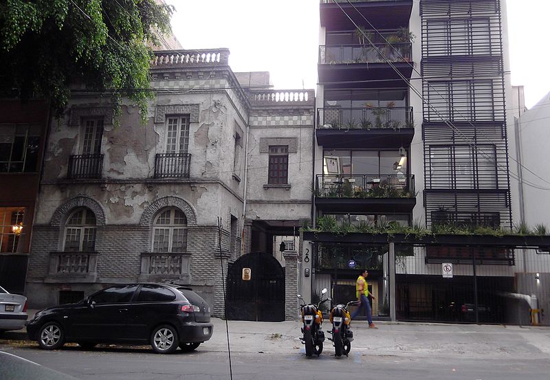 A 1920's neoclassical style house next to a loft's tower in Mexico City's Roma Norte neighborhood, which is under gentrification and repopulation from 2000