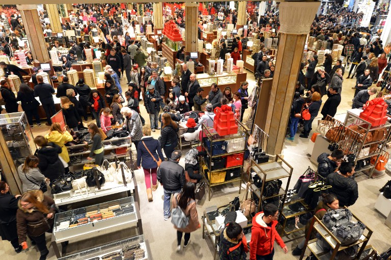 People shopping in a crowed Macy's department store.