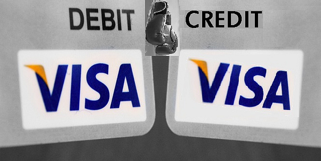 Image showing the corners of two Visa cards---one is a debit card and the other is a credit card.