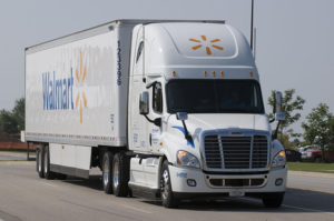 A semi-truck with the Walmart name and logo on the side of the truck