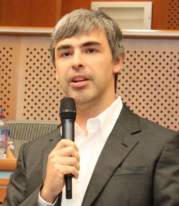 Picture of Larry Page speaking into a handheld microphone