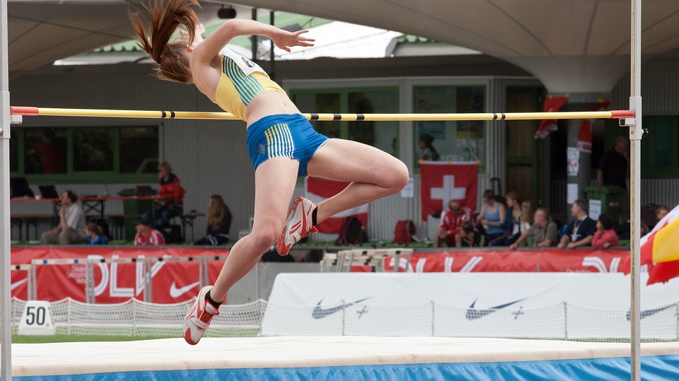 Female high jumper in mid jump