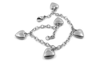 Image of a silver chain charm bracelet with five silver heart charms.