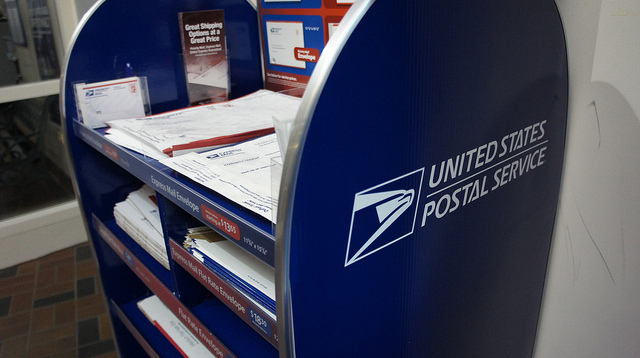 Photograph of envelopes and priority packaging options at the Post Office.