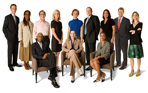 A group of 12 individuals (5 men and 7 women). There are four persons of color in the group.
