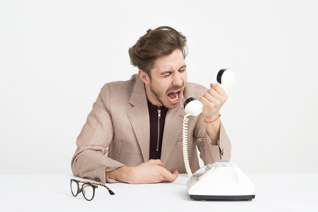 A man yelling into a phone