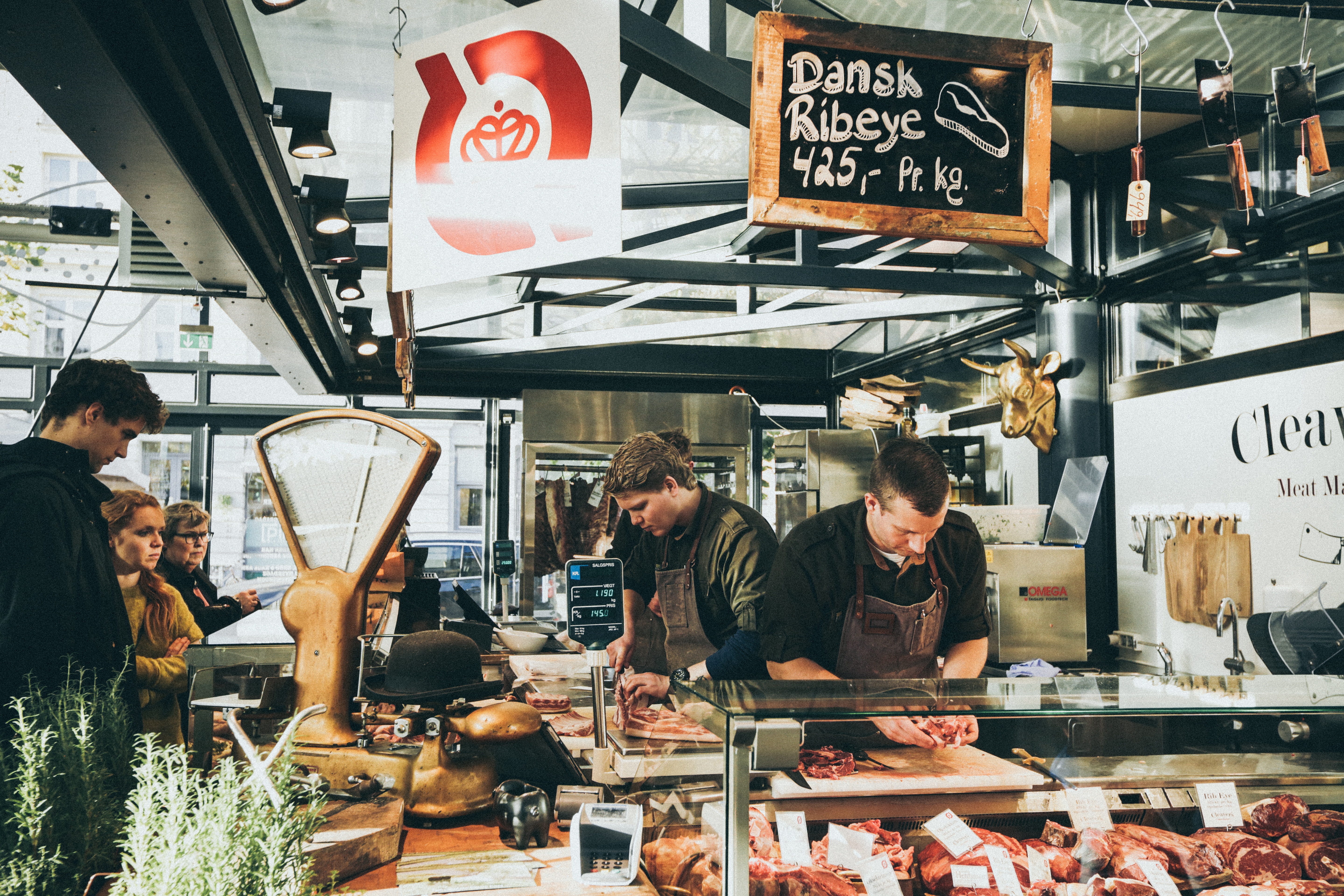 two people working in an open air meat market.