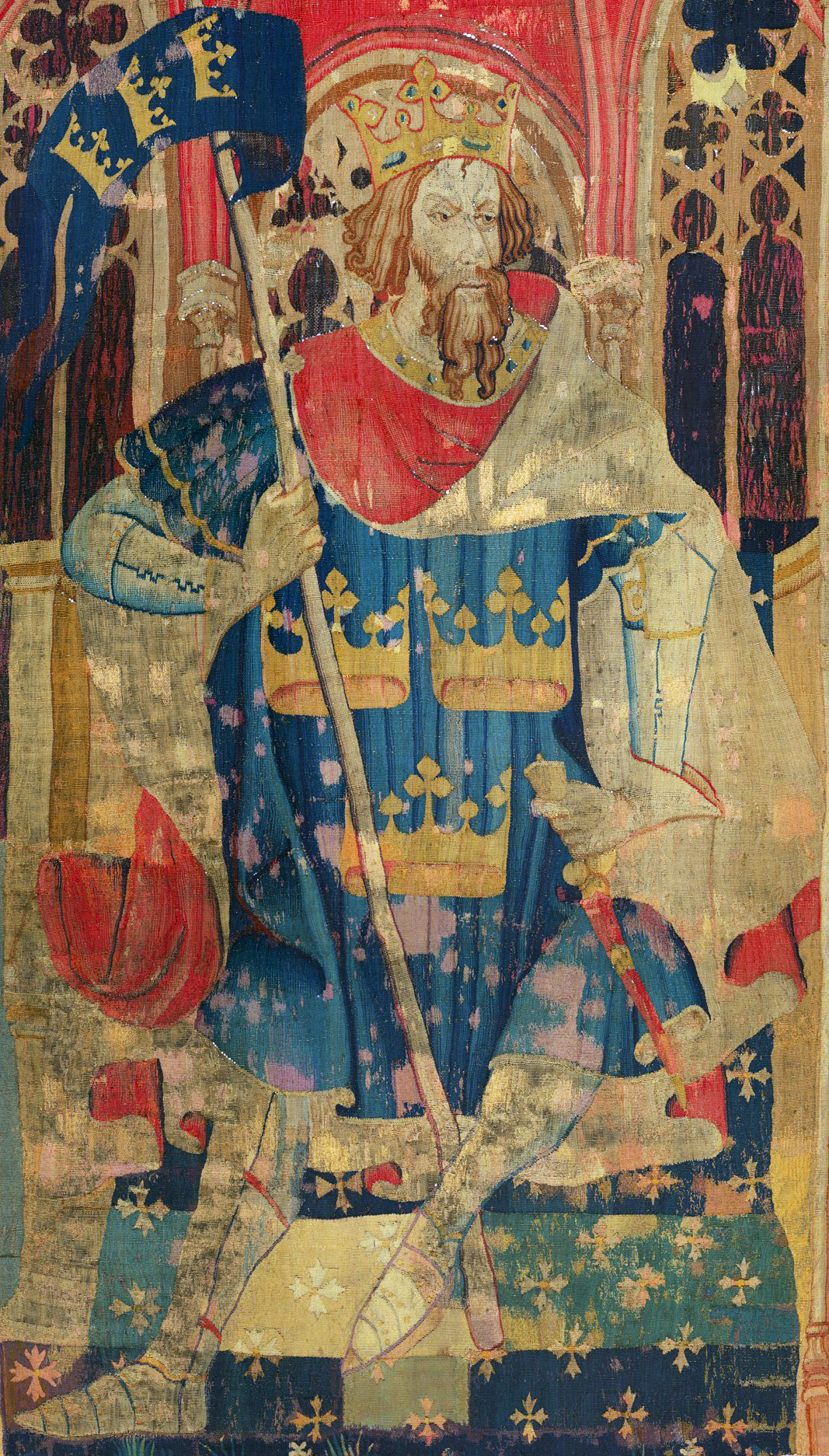 A tapestry depicting King Arthur sitting on a throne, holding a banner.