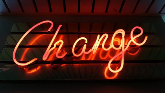 A neon sign with the word change