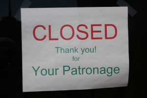 Sign taped to a door that reads 'CLOSED. Thank you! For Your Patronage."