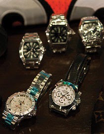 Five faux Rolex watches sit on a table.