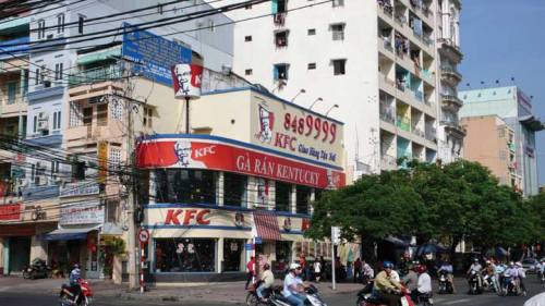 A KFC franchise in Asia. The store has at least two floors, very large windows, and very big signs.