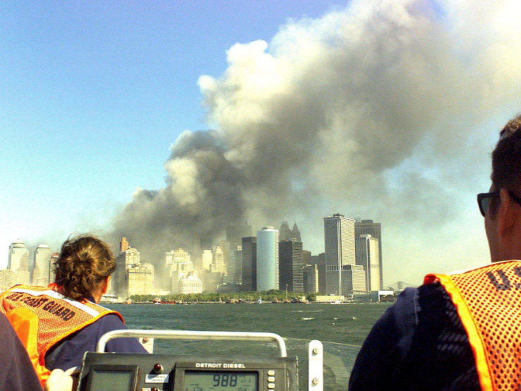 members of the coast guard witness the collapse of the twin towers from a boat 
