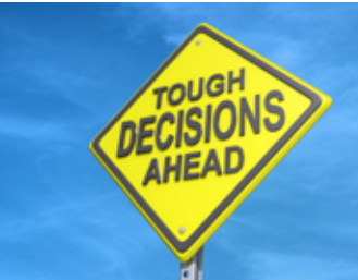 Sign saying Tough Decisions Ahead