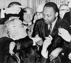 President Lyndon Johnson shakes hands with Martin Luther King Jr. after presenting him with one of the pens used to sign the Civil Rights Act of 1964.