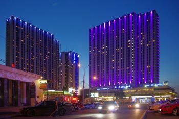 Photo of the Izmailovo Hotel complex at night.