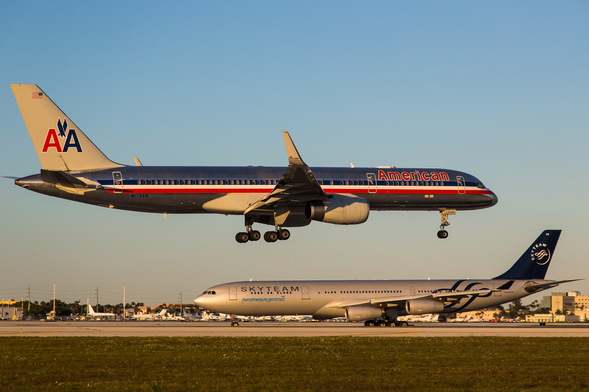 An American Airlines plane is landing at an airport.