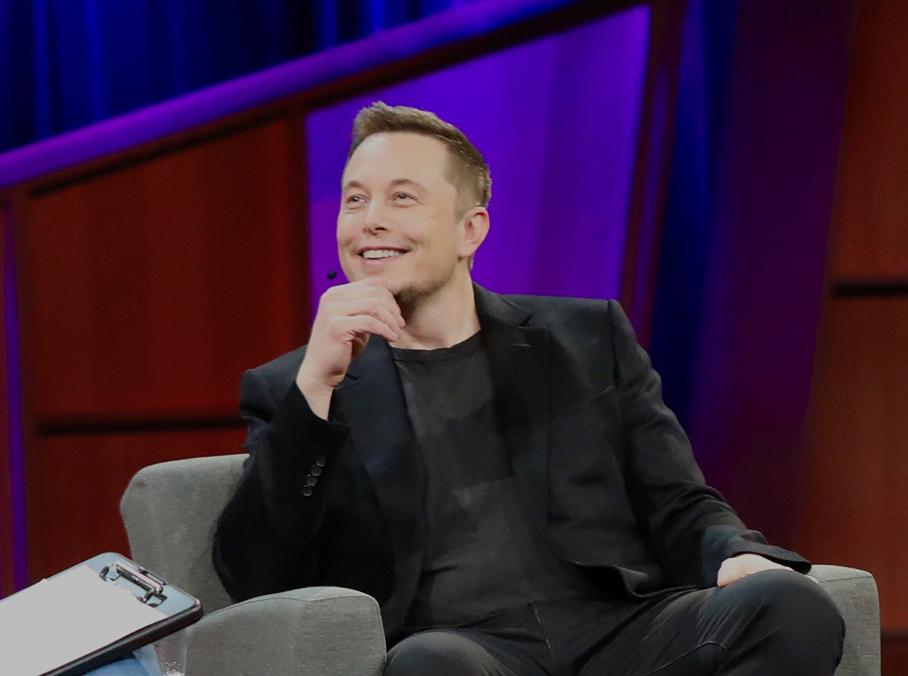 A photograph shows Elon Musk