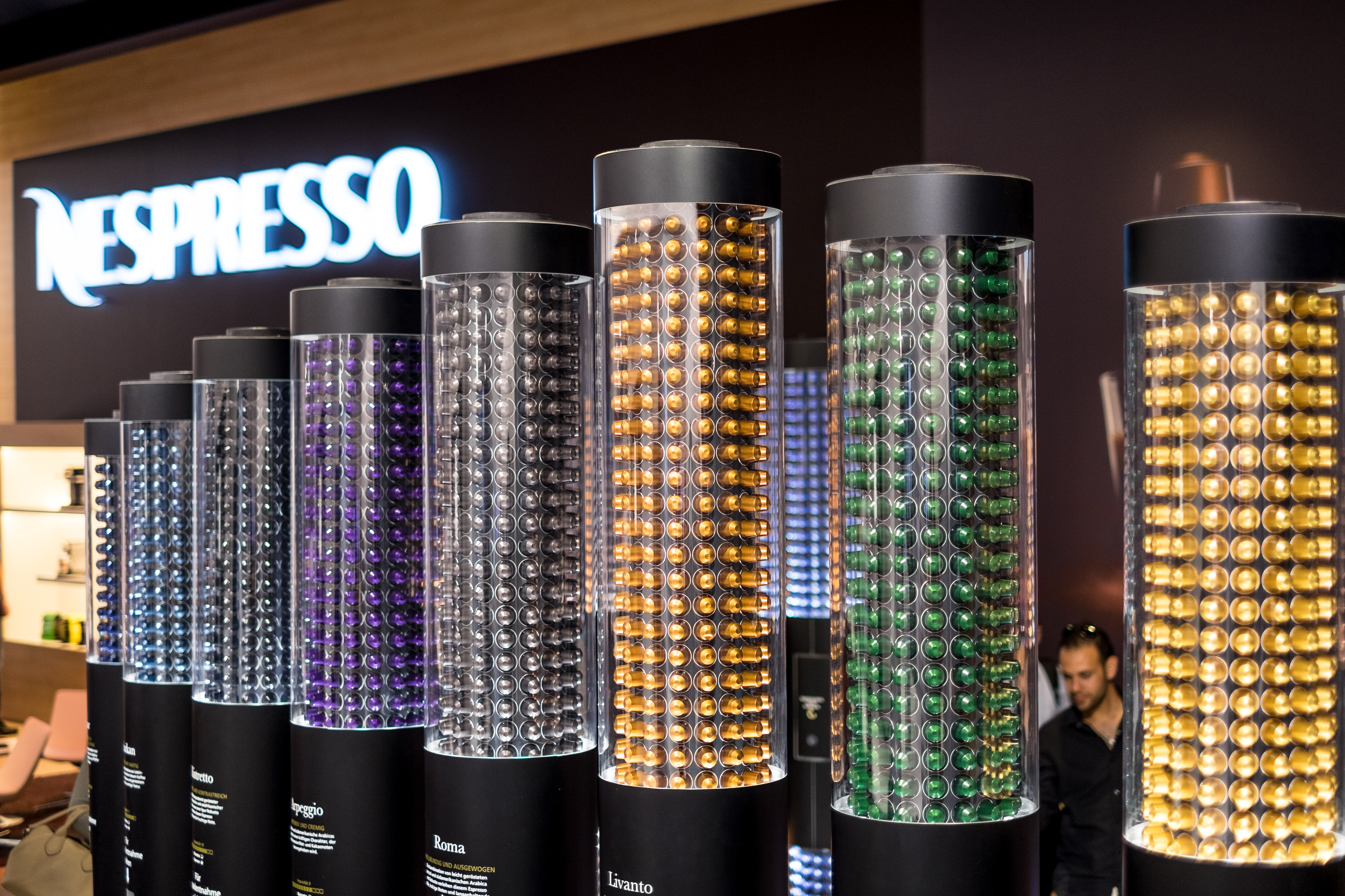 Une photographie montre une exposition de toutes les petites dosettes de café en plastique fabriquées par Nespresso.
