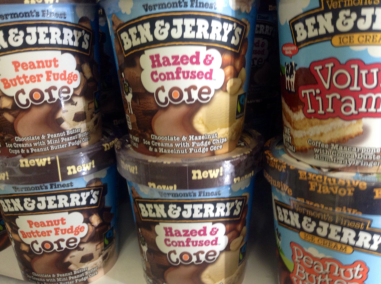 A photograph shows stacks of Ben and Jerry's ice cream pints.