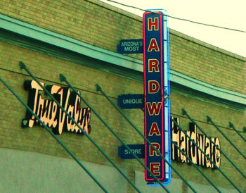 Photo of a True Value Hardware store sign on the side of a brick building, with additional signage that reads, "Arizona's most unique store."