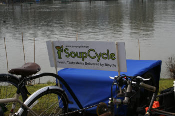 Photo of a bicycle with carrier on the back and an add for the business, "Soup Cycle: fresh, tasty meals delivered by bicycle." 