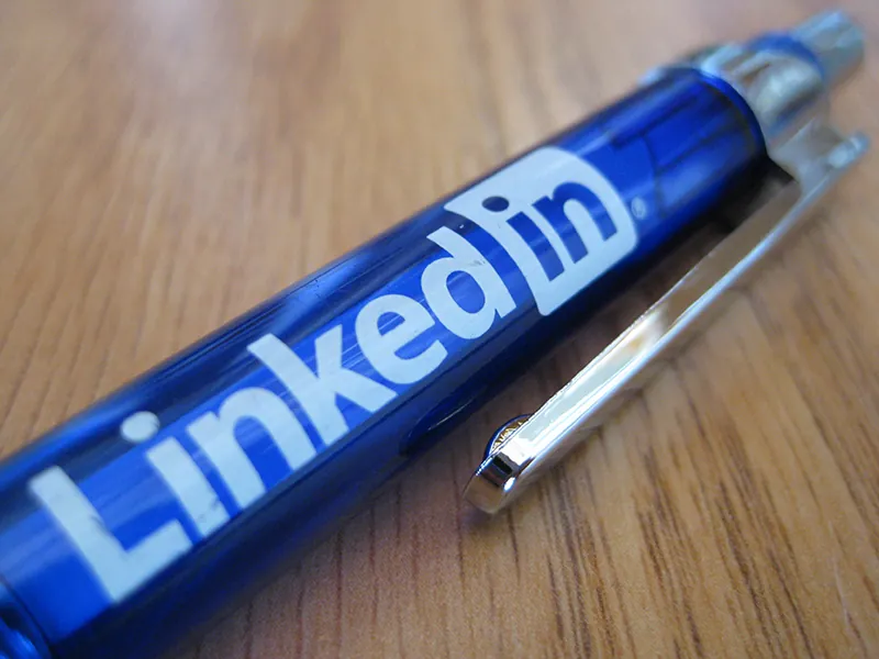 A pen with the LinkedIn logo is on a table.