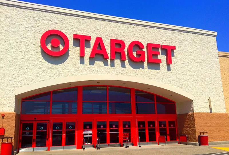 A Target storefront shows it’s trademark bullseye to the left of the store name and over the store entrance.