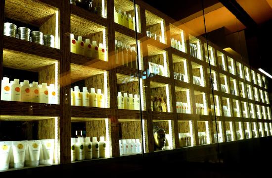 Photo of row of salon shelves full of hair-care products.