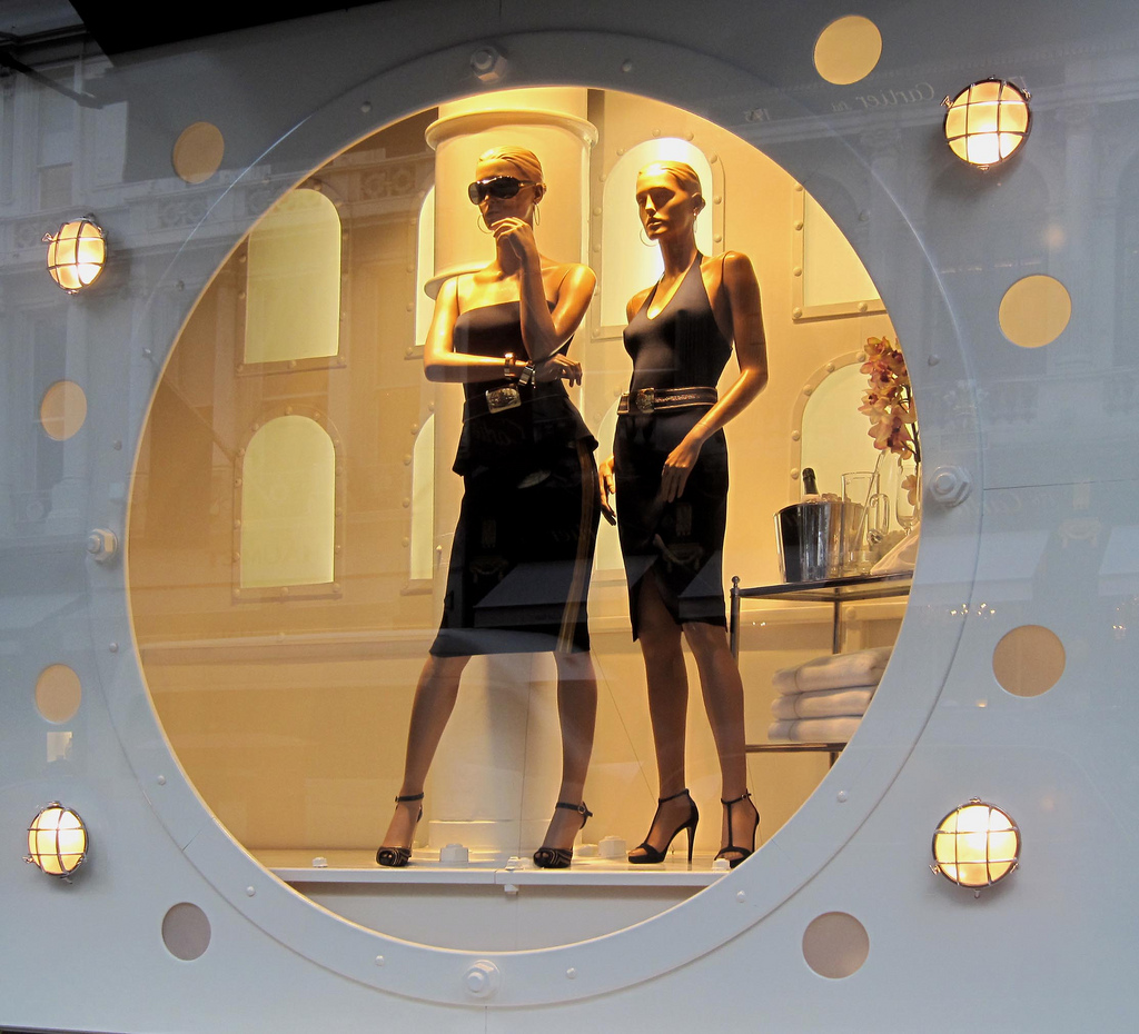Photo of two female mannequins wearing black dresses in a Ralph Lauren display window.
